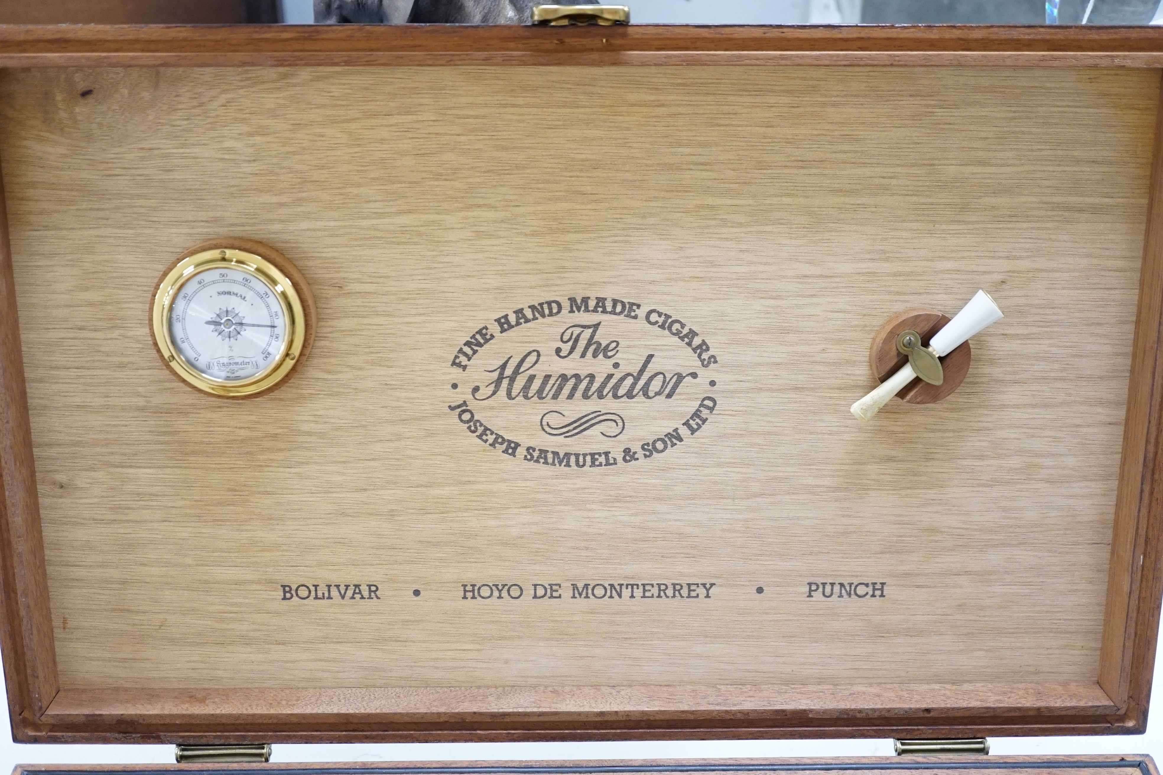 A Joseph Samuel & Son brass mounted humidor. 44cm wide x 27cm deep